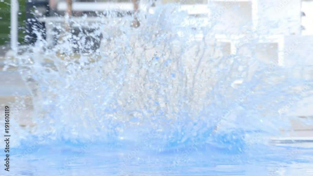 Girl run and jump in swimming pool, pops up and smile Girl run and jump in swimming pool, pops up and smile
