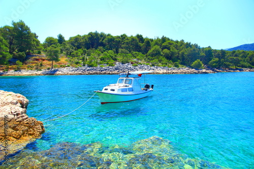 Boat fixed on rocky beach, beautiful blue sea, Island Hvar, Croatia © Simun Ascic