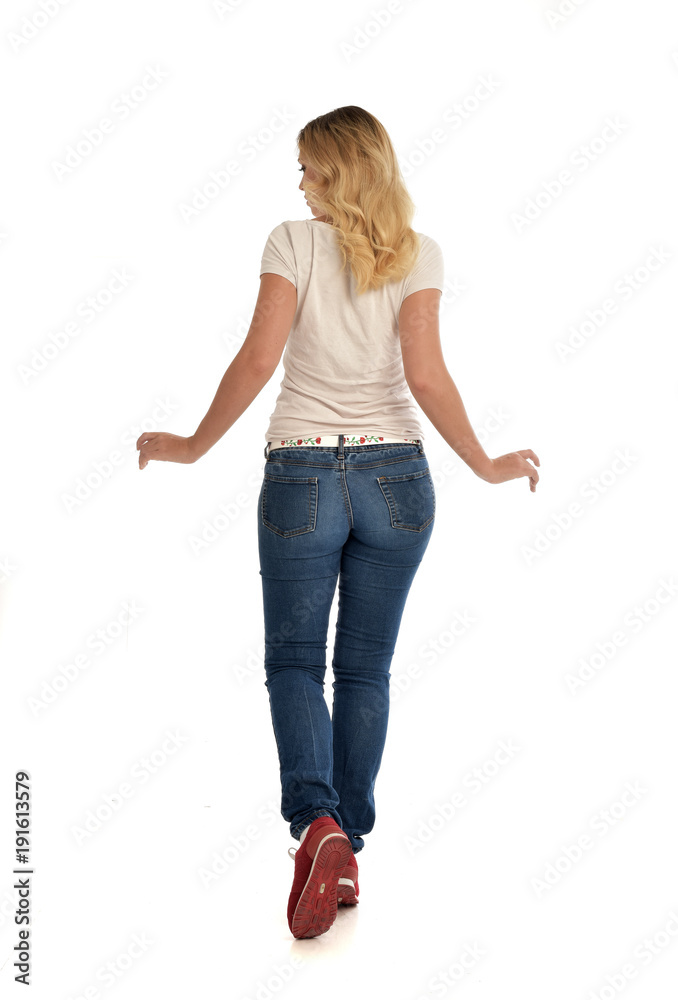 full length portrait of blonde girl wearing simple white shirt and jeans, standing pose, isolated on white studio background. full length portrait of blonde girl wearing simple white shirt and jeans, standing pose, isolated on white studio background.