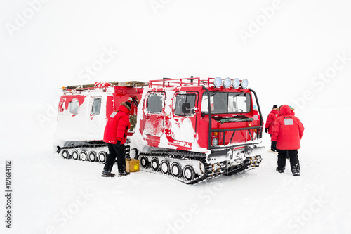 A group of researchers with a tracked vehicle in Antarctica