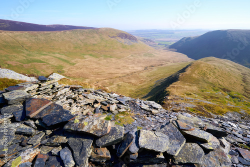 Looking down a ridge towards Bannerdale from Bannerdale Crags, Bowscale Fell in the English Lake District, UK. photo