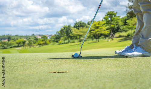 Golfer put golf ball on tee preparing shot on to golf hole