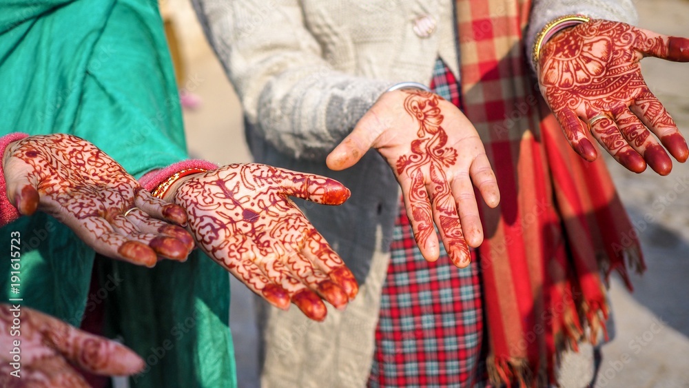 Closeup of hands with henna art.