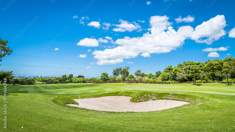The sand Bungker in golf course with blue cloud sky background