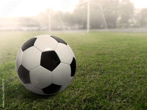Soccer ball on a grass football field, under the sunset © Retouch man
