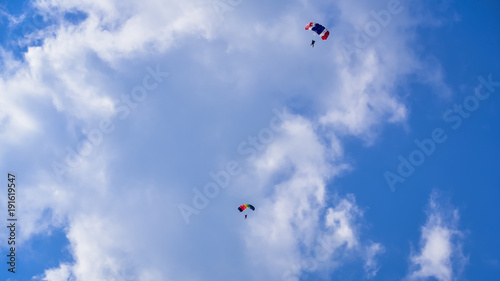 Skydriver jumping with parachut with blue cloud sky background