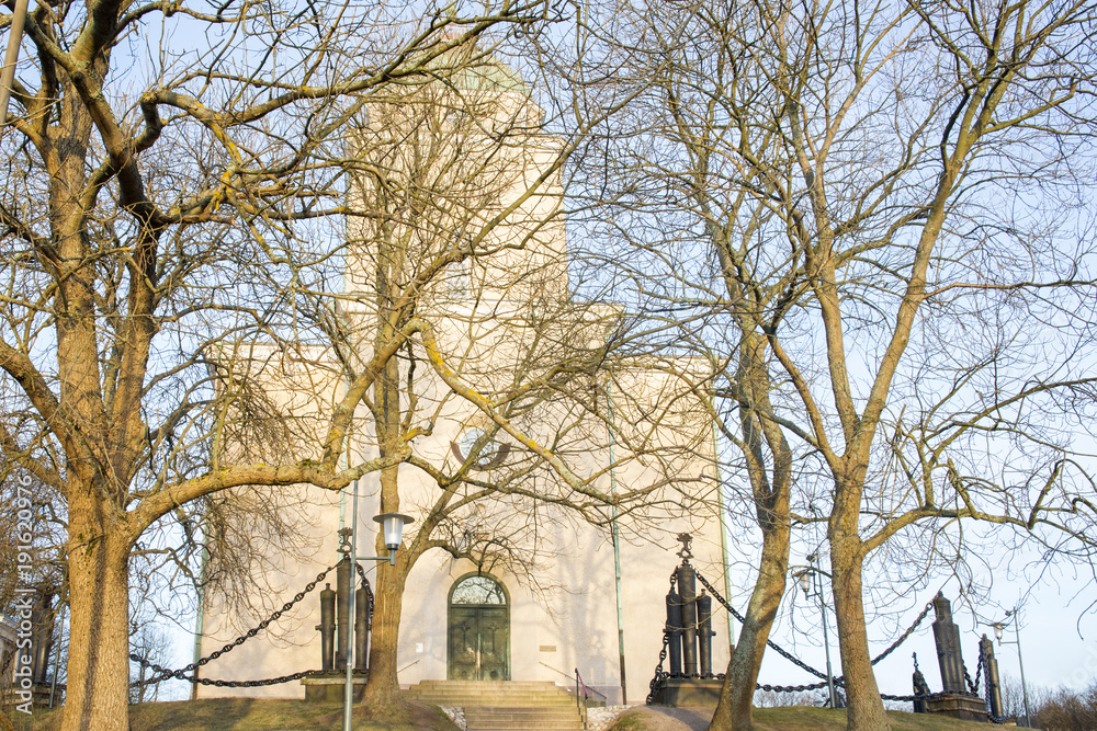 View of some trees in front the Suomenlinna Church in Helsinki, Finland. The Orthodox church was converted into an Evangelical Evangelical church during the 1920s.