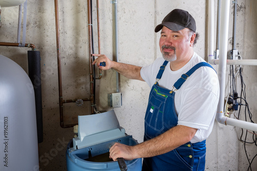 Konstfotografi Friendly workman working on a water softener