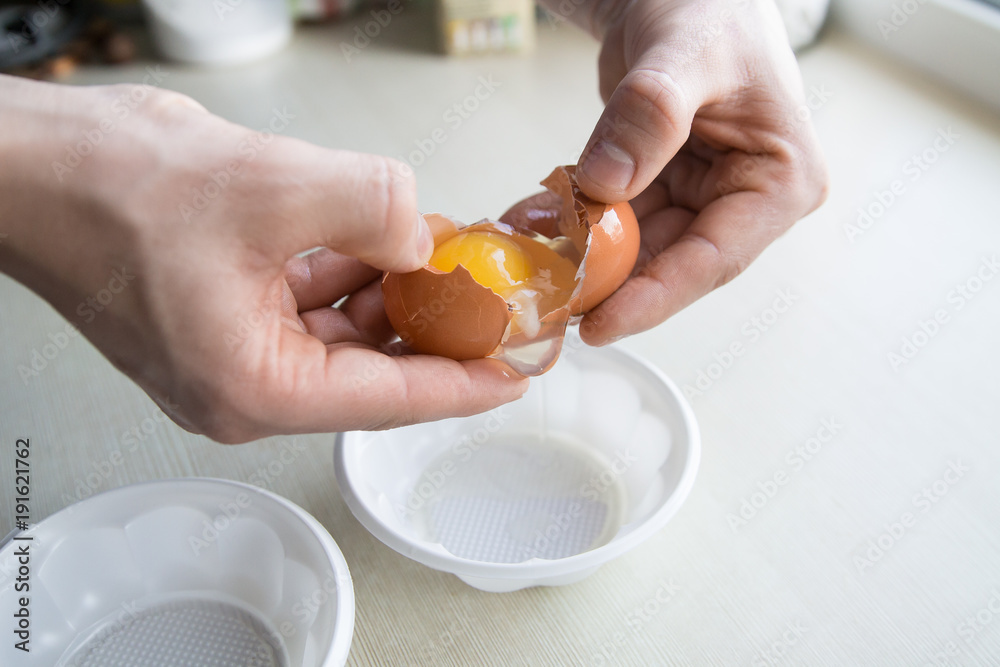 man's hands breaking egg shell while coking man's hands breaking egg shell while coking