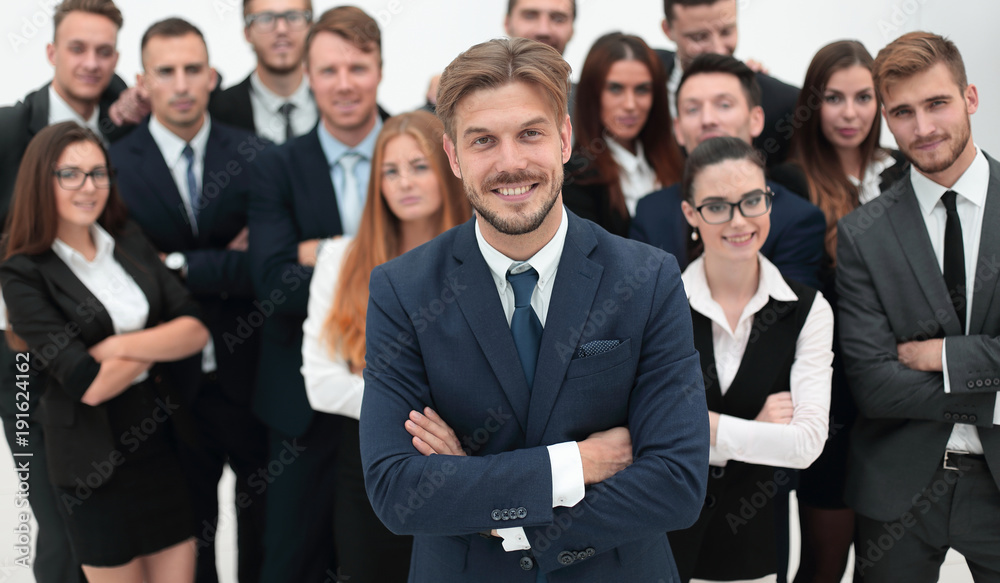 smiling businessman standing on background of her business team. smiling businessman standing on background of her business team.