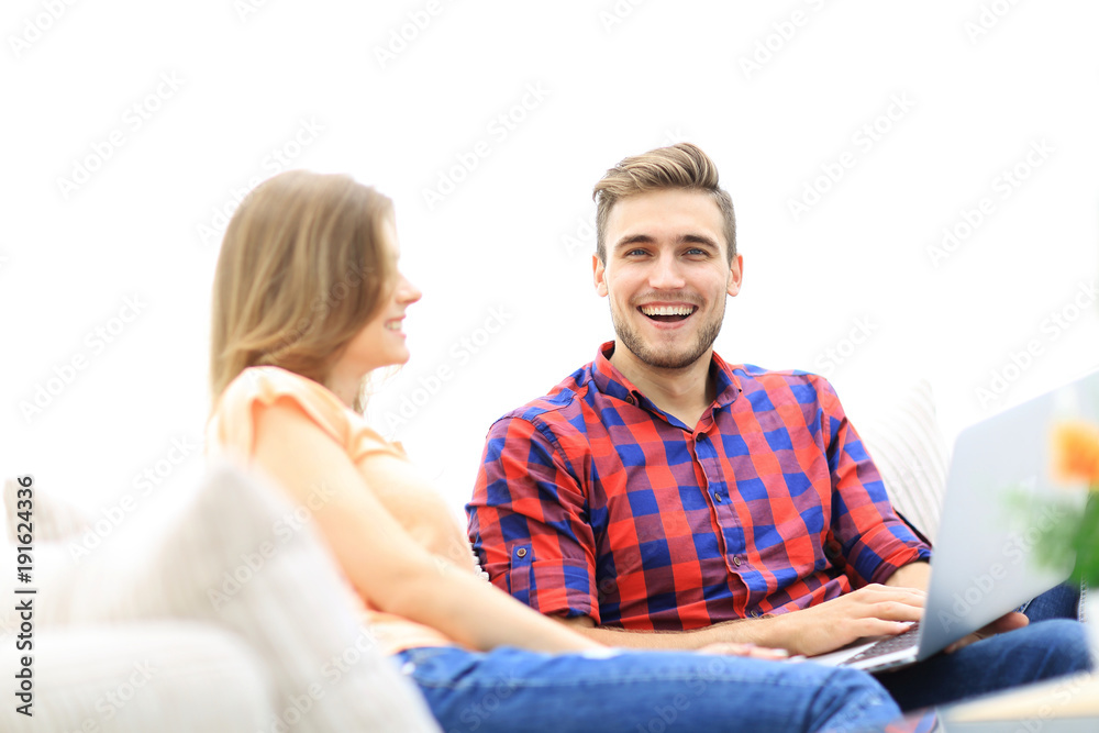 young man and his girlfriend cheering for their team while sitting on the couch young man and his girlfriend cheering for their team while sitting on the couch