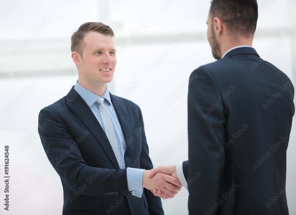 handshake financial partners in the corridor of the office handshake financial partners in the corridor of the office