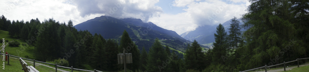 panoramic photo of mountain landscape in Valtellina, mountains in spring, path, Bormio, Lombardy, Italy