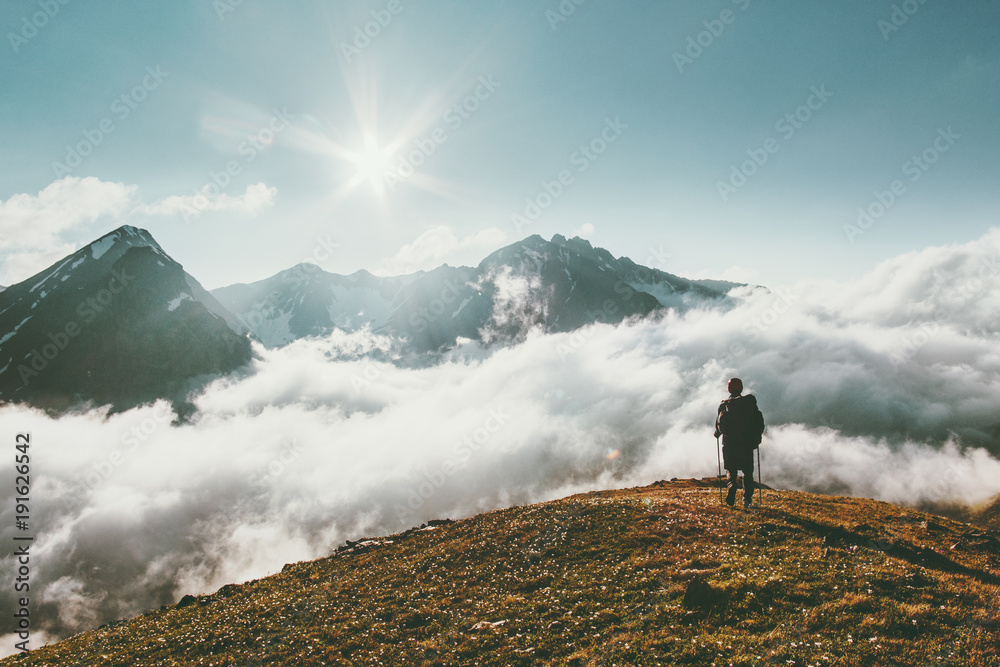Traveler hiking in mountains clouds landscape Travel lifestyle adventure concept summer vacations outdoor