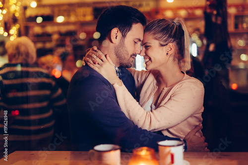 Romantic couple dating in pub at night