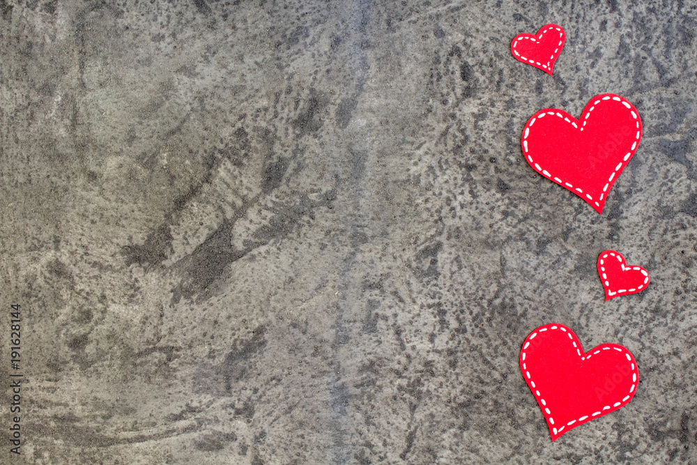 Red hearts on gray concrete background. Copy space. Top view. Red hearts on gray concrete background. Copy space. Top view.