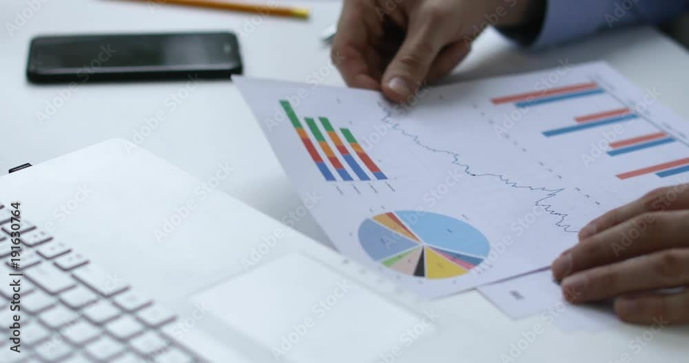 paperwork - man analyzing financial reports in office
