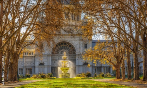 A row of trees leading to a fountain in front of the royal exhibition building at Carlton Gardens in Melbourne, Australia. photo