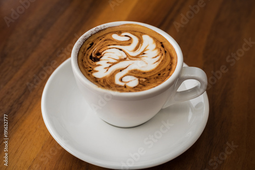 Single cup of coffee with artistic foam display