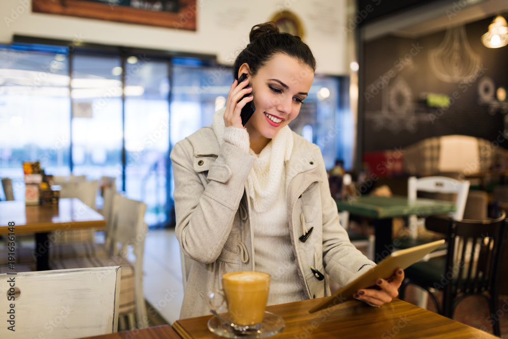 Attractive young woman using tablet in cafe Attractive young woman using tablet in cafe