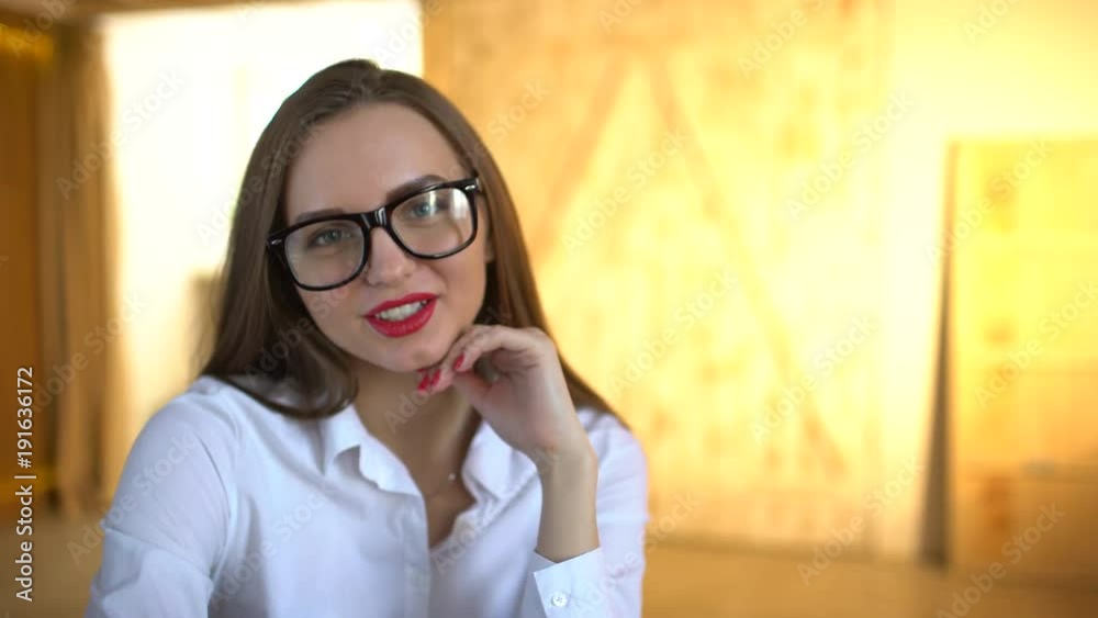 young woman using tablet computer at office. look at camera. 4 k