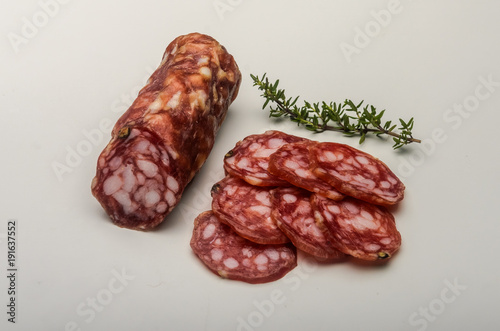 Sliced appetizing Italian sausage salami isolated on white background