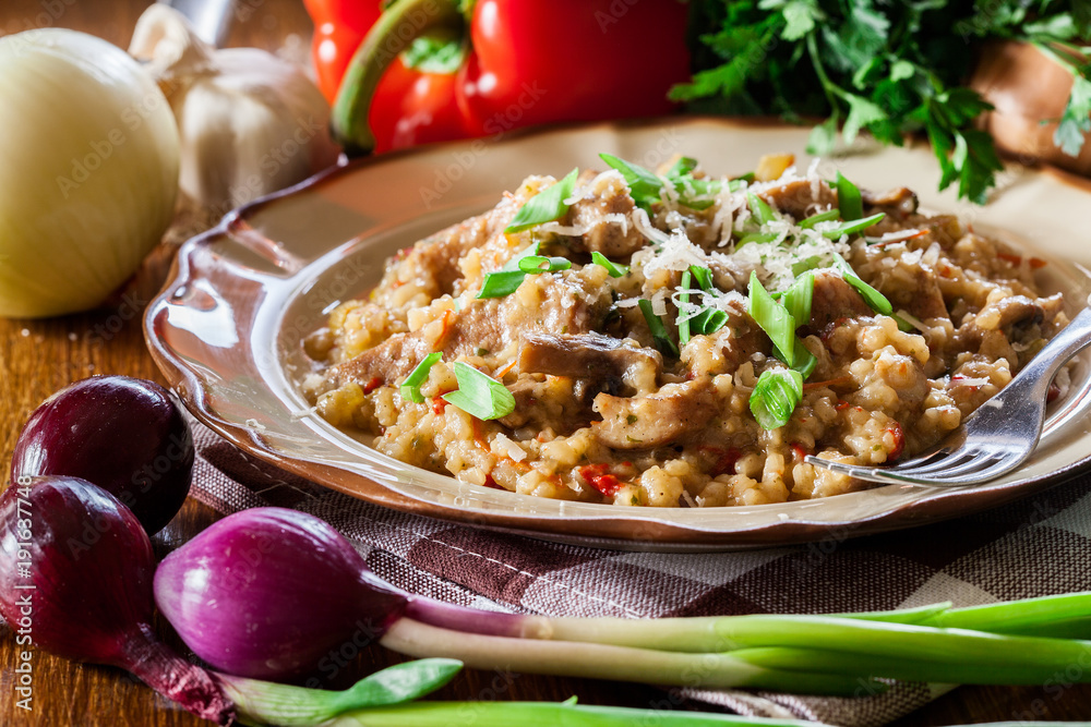 Risotto with champignon mushrooms, pork and parmesan Risotto with champignon mushrooms, pork and parmesan