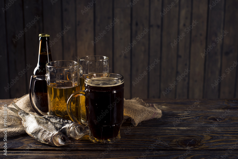 glass of beer, salted fish and nuts on a wooden table glass of beer, salted fish and nuts on a wooden table