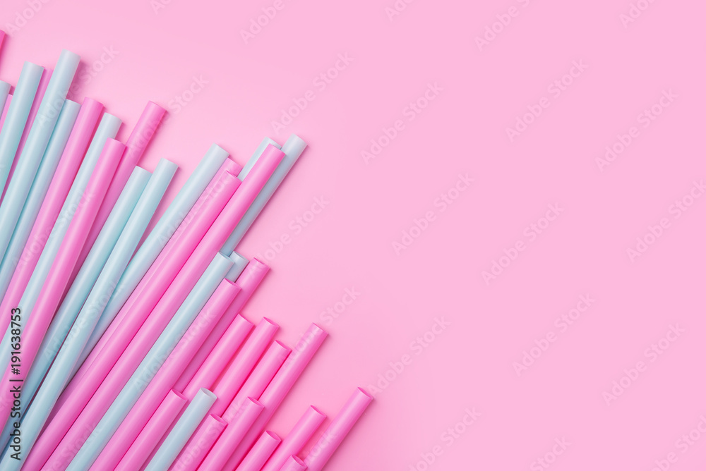 colorful cocktail tubes lie on a bright pink background. Top view image. Copyspace for your text. colorful cocktail tubes lie on a bright pink background. Top view image. Copyspace for your text.