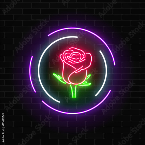 Glowing rose neon sign of flower shop in round frames on dark brick wall background. Design of floral store signboard.