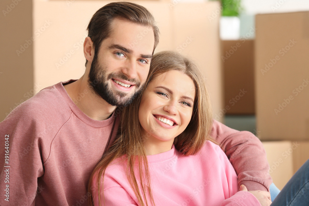 Young couple in room at new home