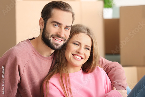 Young couple in room at new...
