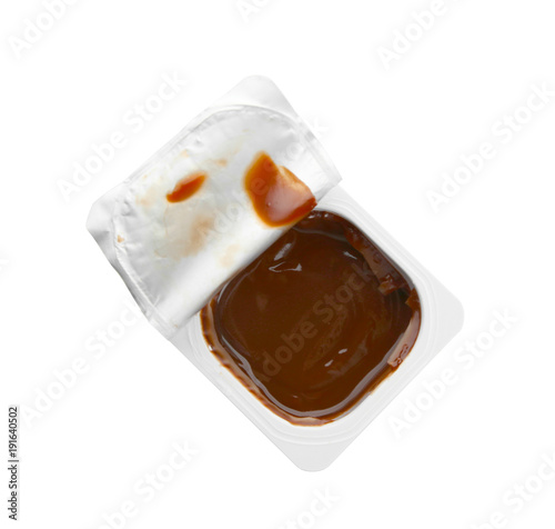 Plastic cup with chocolate yogurt on white background