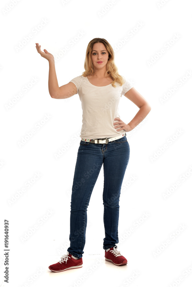 full length portrait of blonde girl wearing white shirt and jeans. standing pose, isolated on white studio background. full length portrait of blonde girl wearing white shirt and jeans. standing pose, isolated on white studio background.