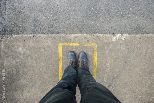 Safety sign for persons to stop before crossing the road by point the finger to make sure that right, left and in front of  it is safe before crossing.