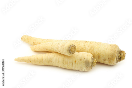 bunch of freshly harvested parsly root on a white background
