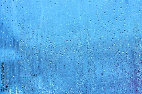 Natural blue water drop background on glass