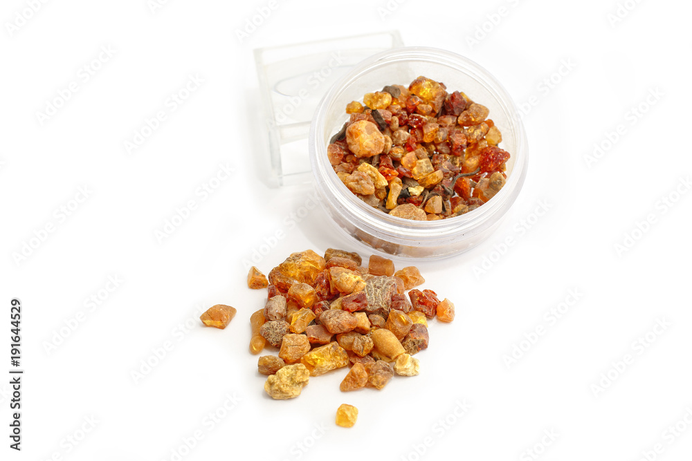 Natural amber. Pieces of amber in the bank and a bunch on a white background. Illustration of how the mineral is mined. Frozen resin in a glass jar. Color amber. The composition of natural stones