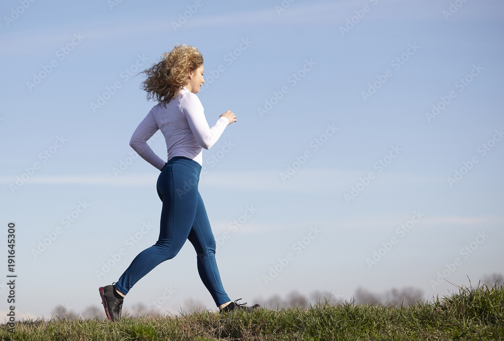 woman running in fall winter season woman running in fall winter season