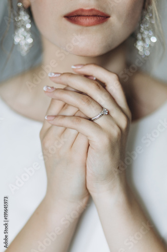 Closeup shot of an elegant, brunette bride in vintage white dres