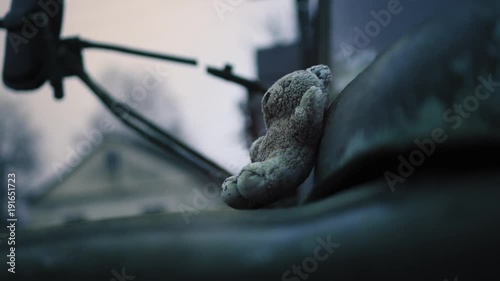 Old abandoned military truck and children's toy. War. Close up toy view