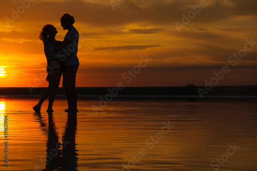 silhouettes of a loving couple at sunset . the concept of love and romance. Card for Valentine's day.