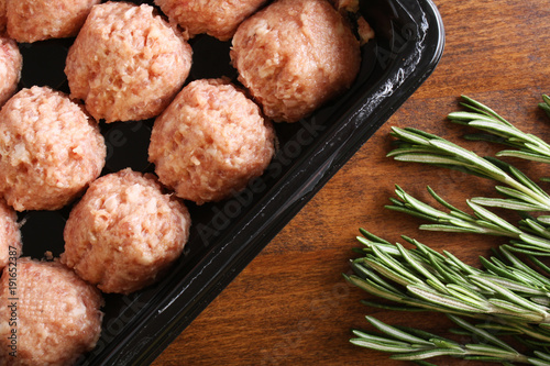 meatball forcemeat beef pork on wooden background rosemary