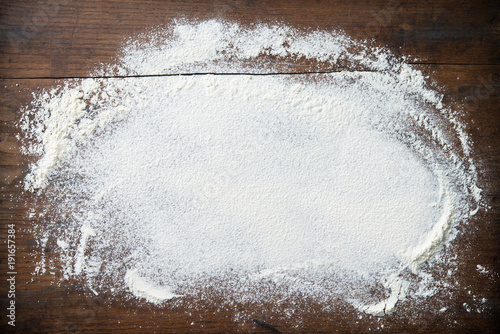 Baking background with flour on wooden table
