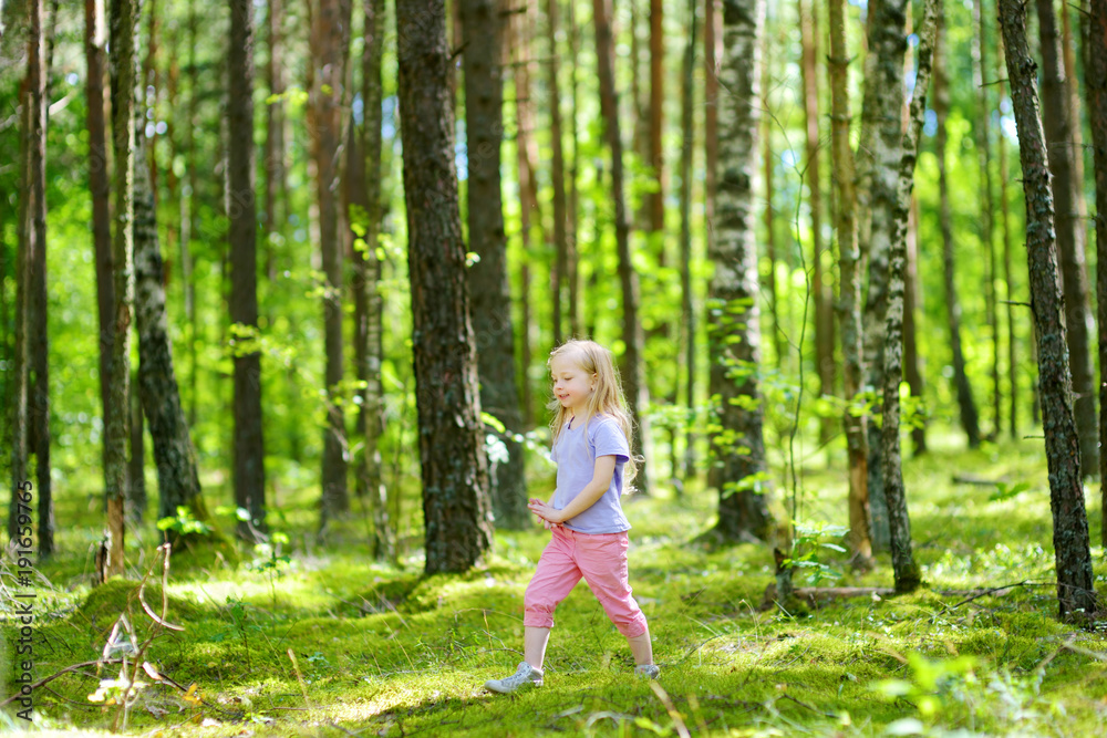 Cute little girl having fun during forest hike on beautiful summer day Cute little girl having fun during forest hike on beautiful summer day