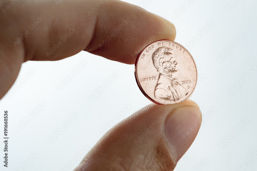 Penny closeup. A male thumb and index finger gripping a one Euro cent Coin. Penny closeup. A male thumb and index finger gripping a one Euro cent Coin.