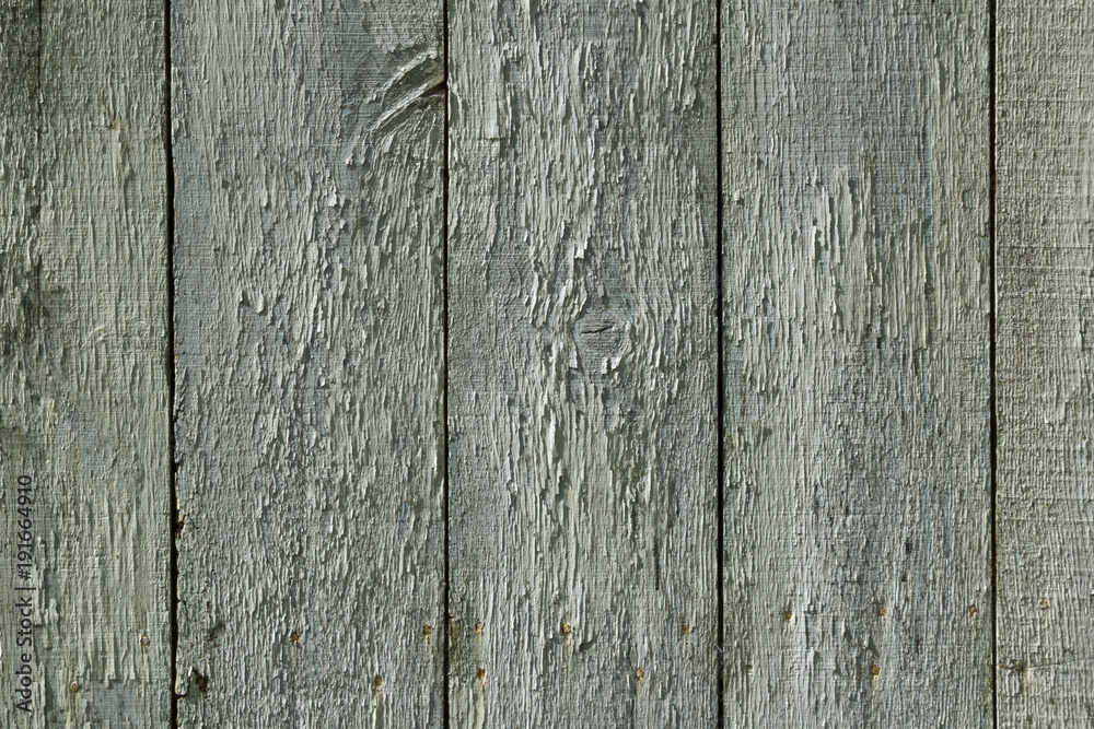 Full frame close up of highly textured flaking paint on an old weathered barn door Full frame close up of highly textured flaking paint on an old weathered barn door