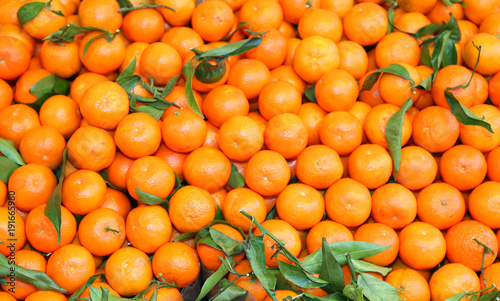 background of ripe mandarins for sale at the fruit market