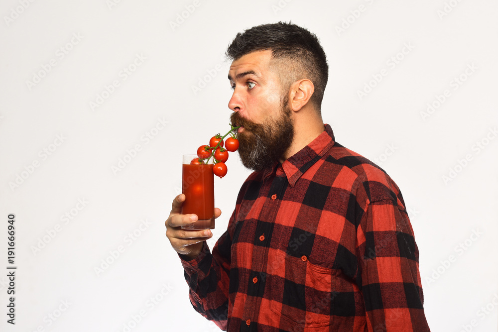 Man with beard drinks tomato juice isolated on white background. Man with beard drinks tomato juice isolated on white background.