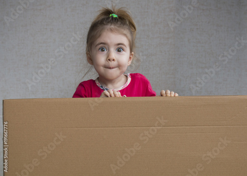 Close up portrait of emotional Little girl holding blank board photo